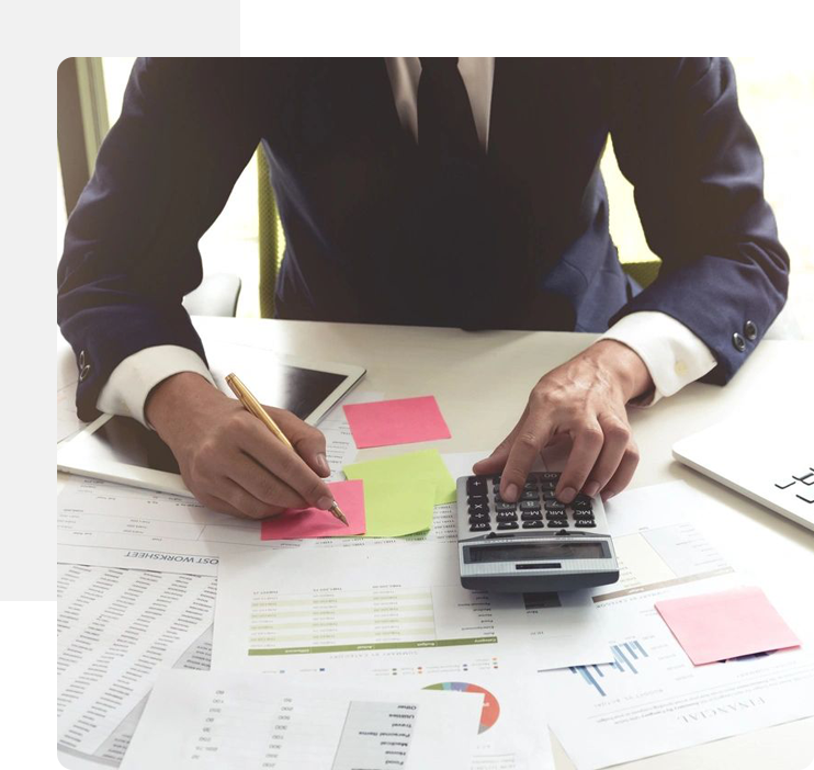 A man in a suit and tie working on papers